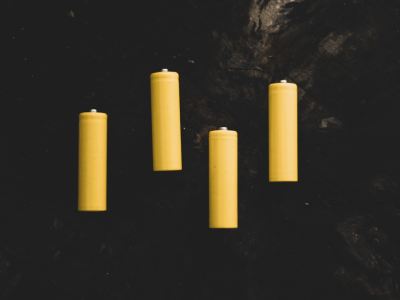 yellow pillar candles on black surface