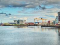 body of water near buildings under cloudy sky during daytime