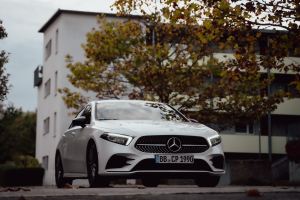 a white car parked in front of a building