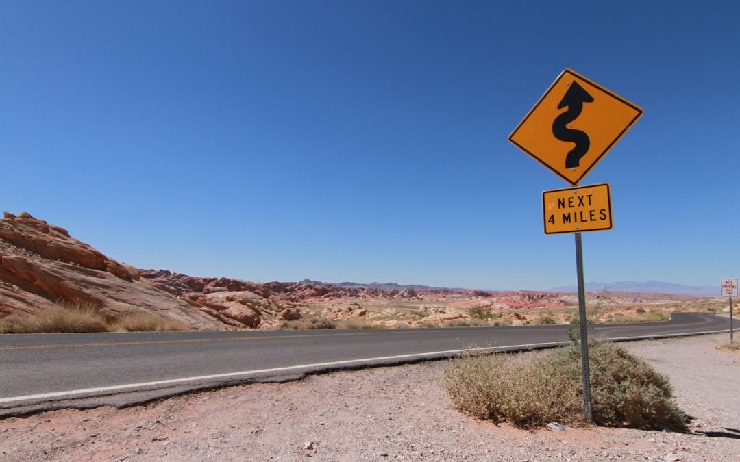 no smoking sign on gray asphalt road during daytime