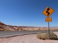 no smoking sign on gray asphalt road during daytime