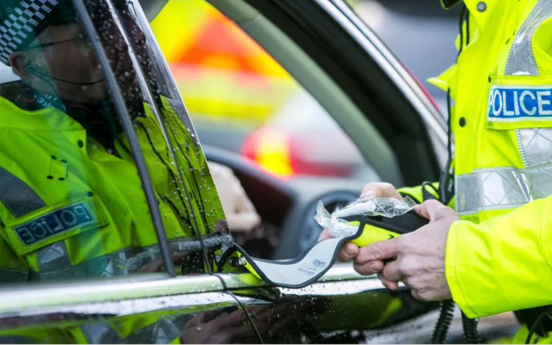 Police officer using breathalyser