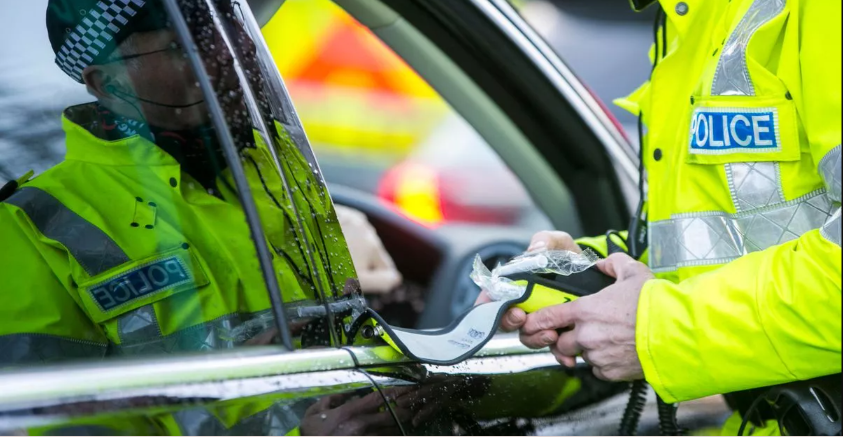 Police officer using breathalyser