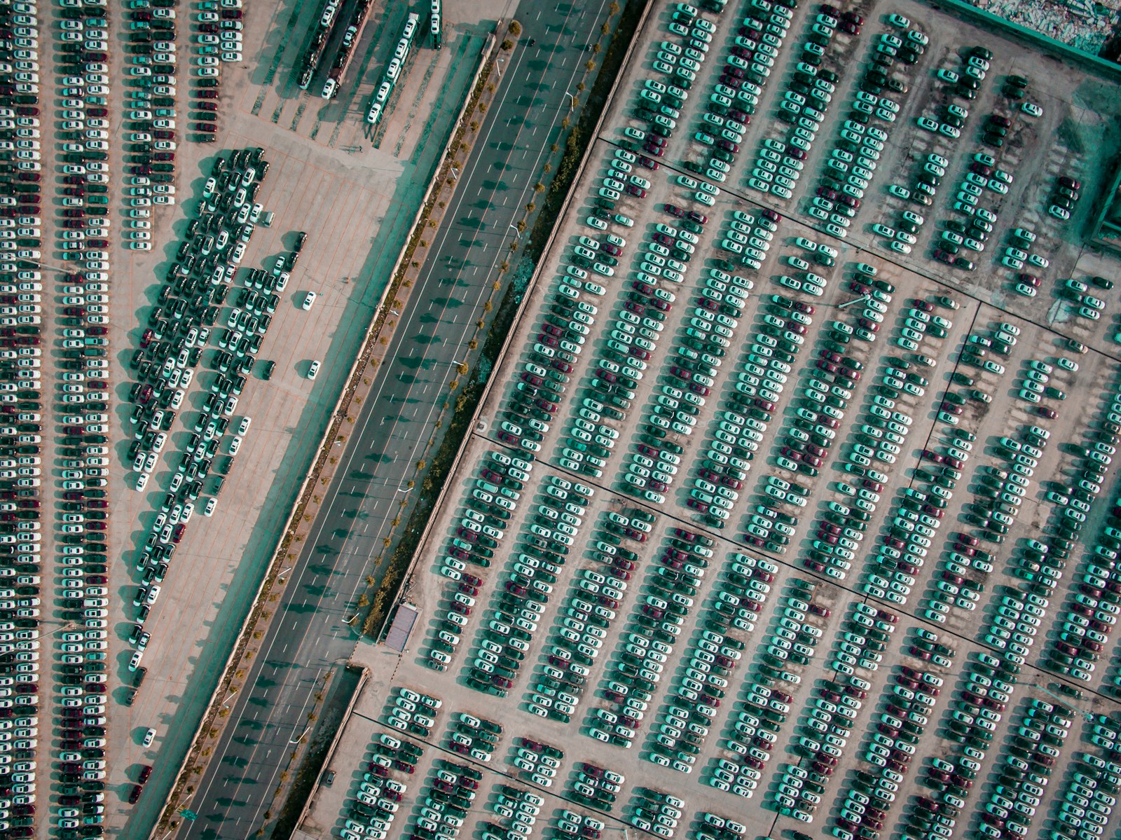 vehicle park on parking lot near gray highway aerial photography