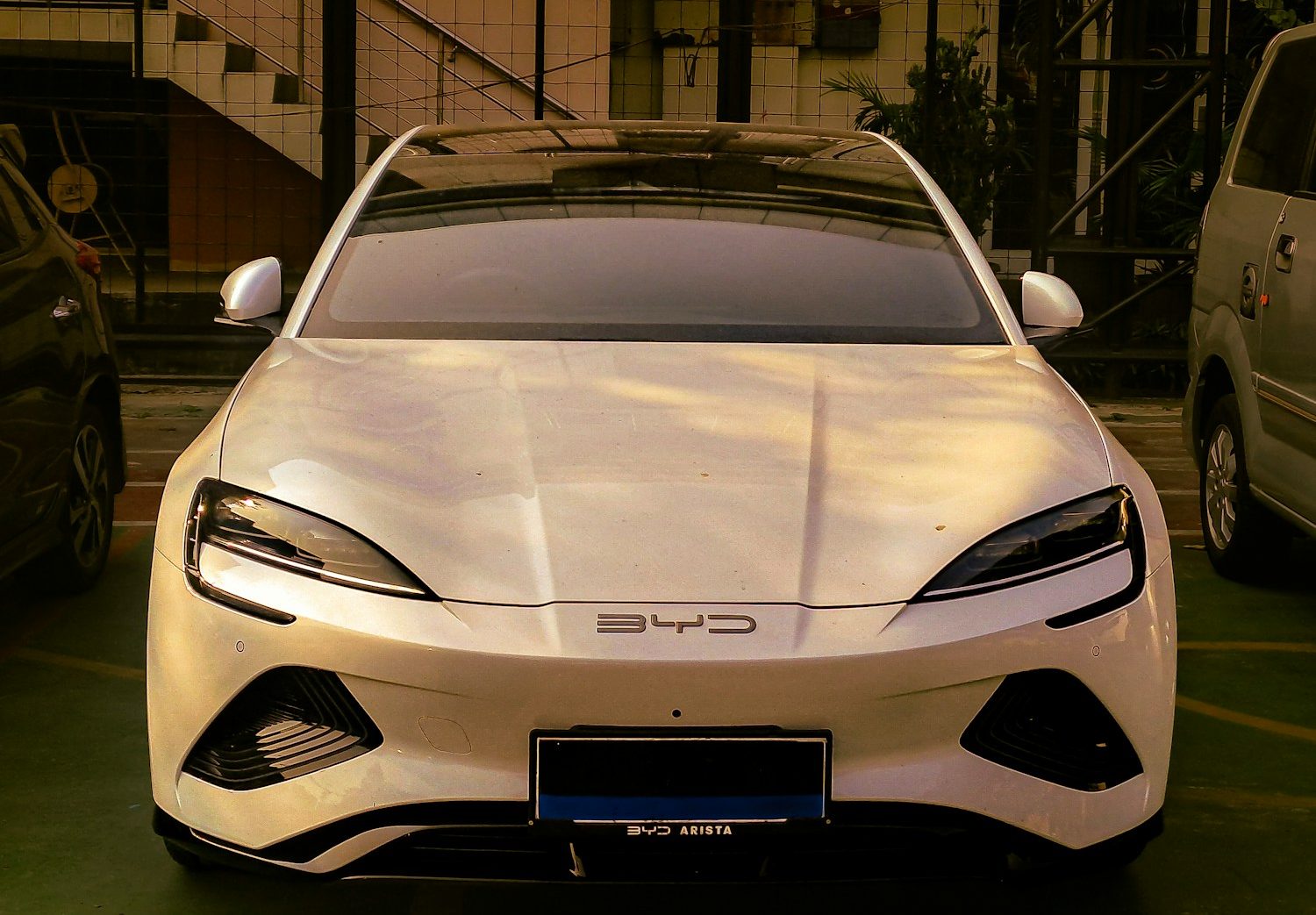 A white sports car parked in a parking lot