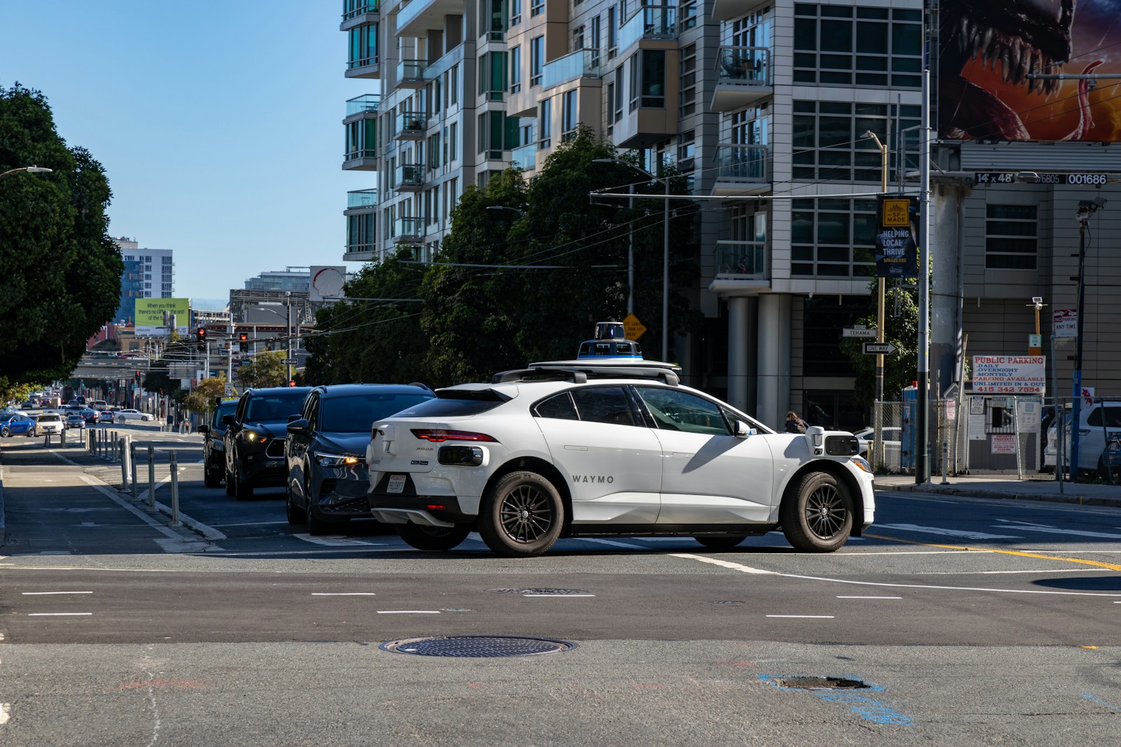 A white car is stopped at an intersection